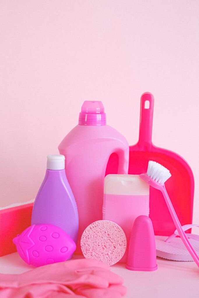 pexels-photo-5218014 Set of assorted plastic containers with gloves brush and scoop for cleaning routine on pink background